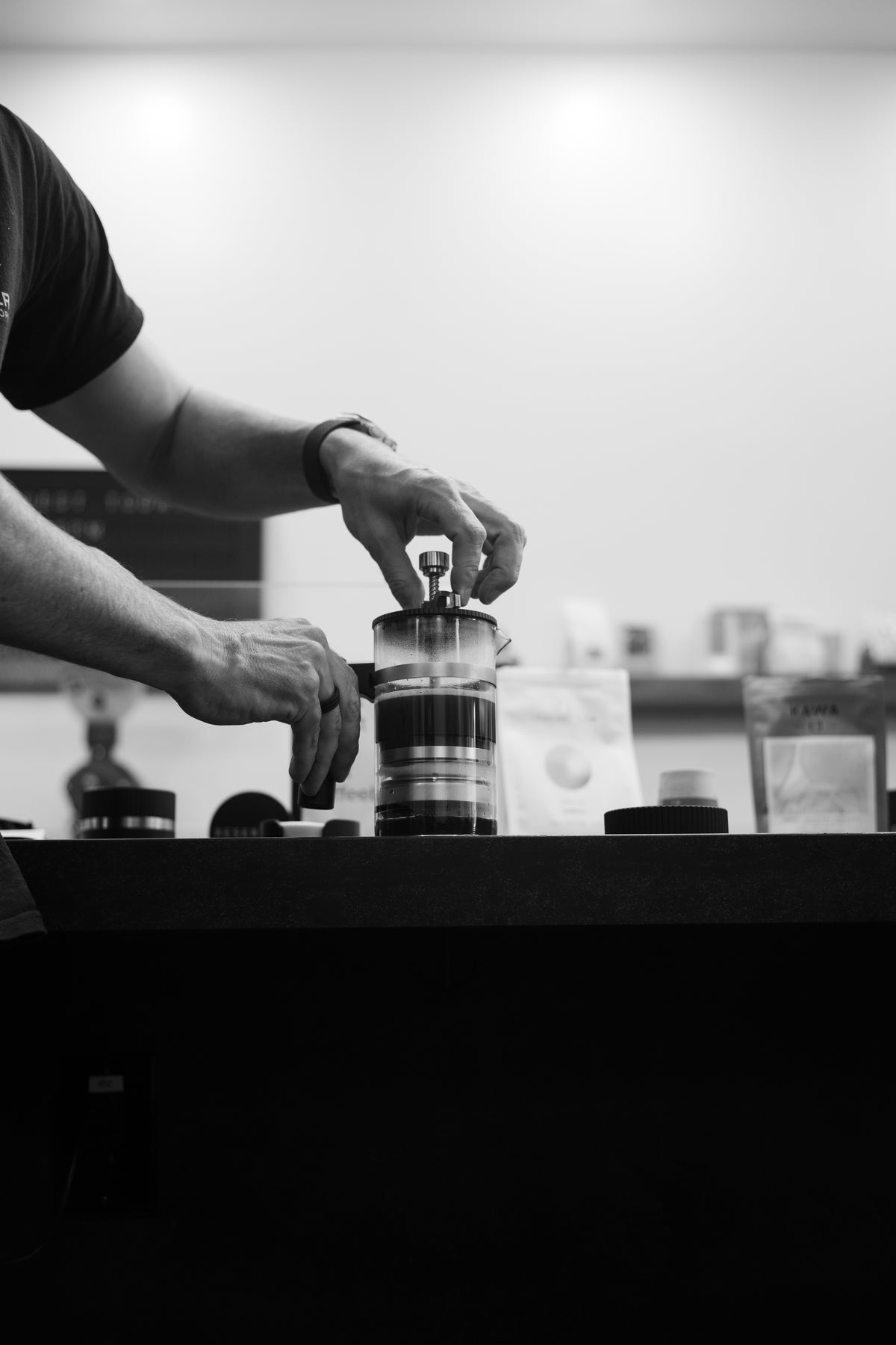 Coffee being stirred in a French press style brewer