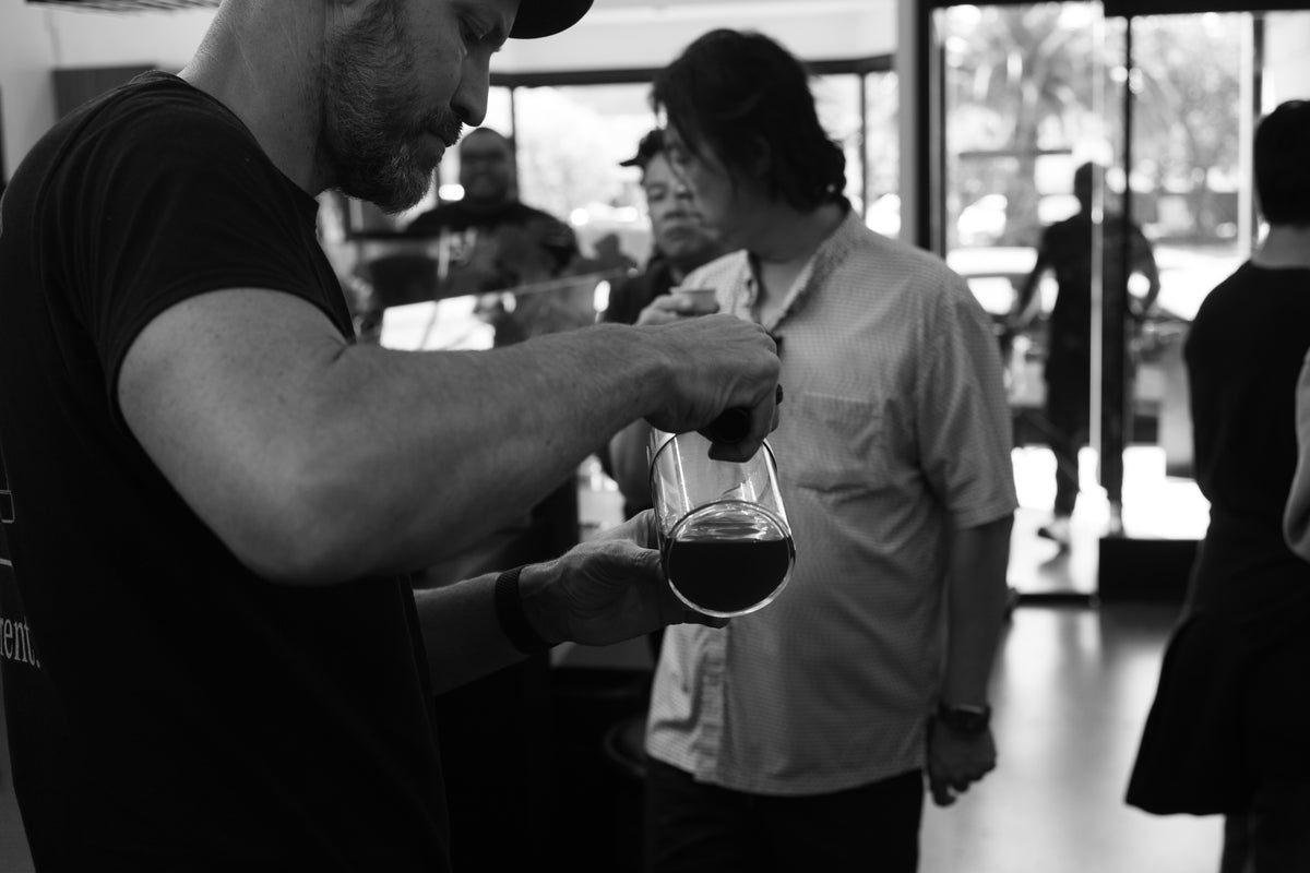 Douglas Weber serving coffee to a workshop attendee