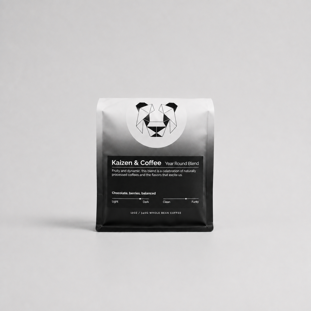 Kaizen & Coffee Year Round Blend whole bean coffee in a black and silver bag on a light gray background.