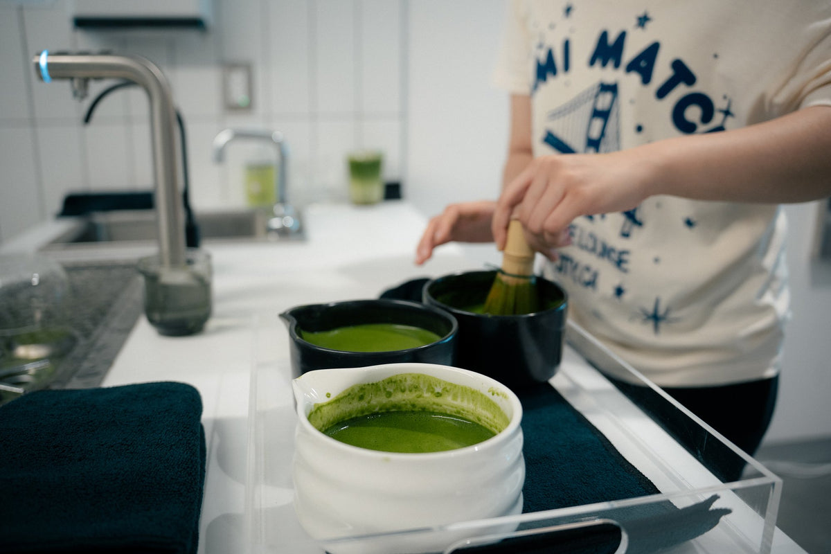Matcha being whisked in ceramic bowls during the Luma Coffee and Nami Matcha event