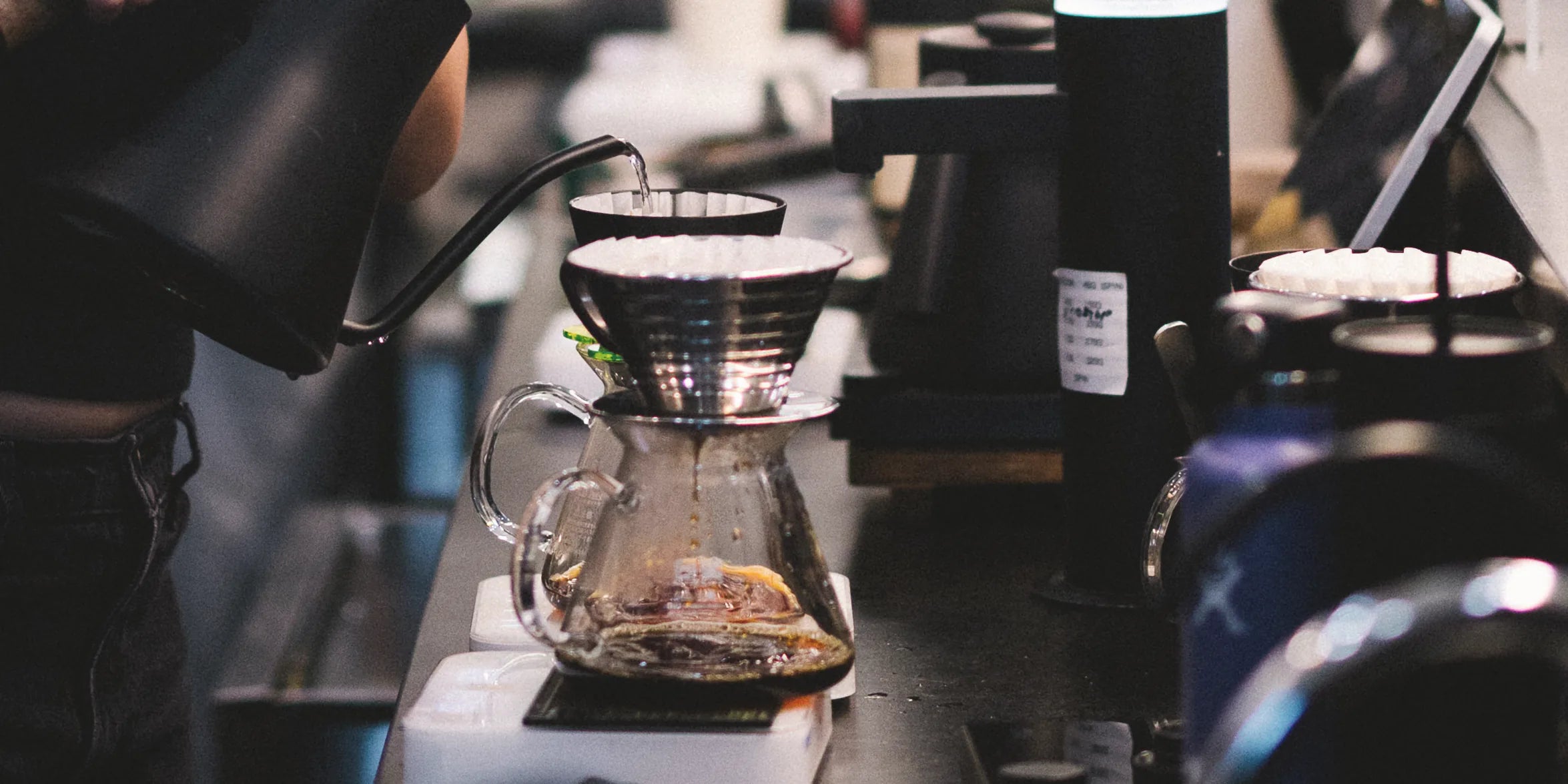 Kettle pouring water into a pour-over coffee brewer
